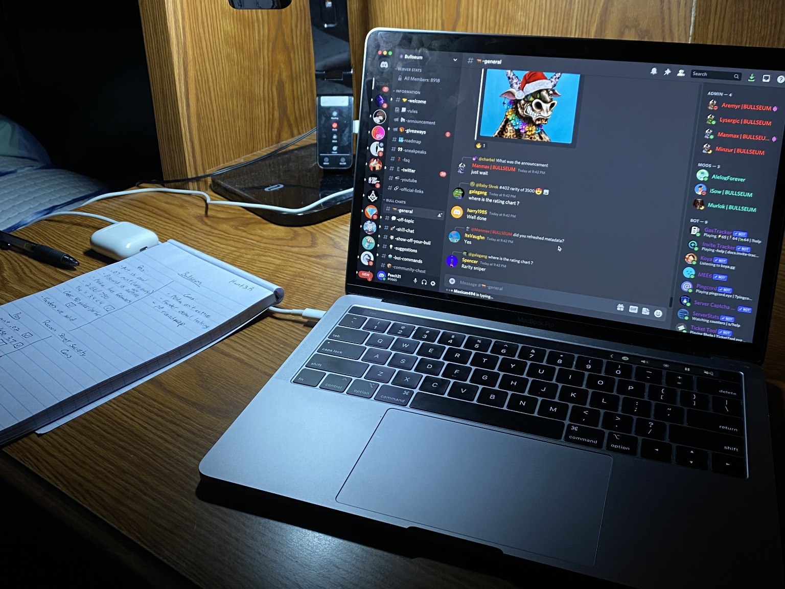 MacBook on a dorm desk with an NFT Discord server open